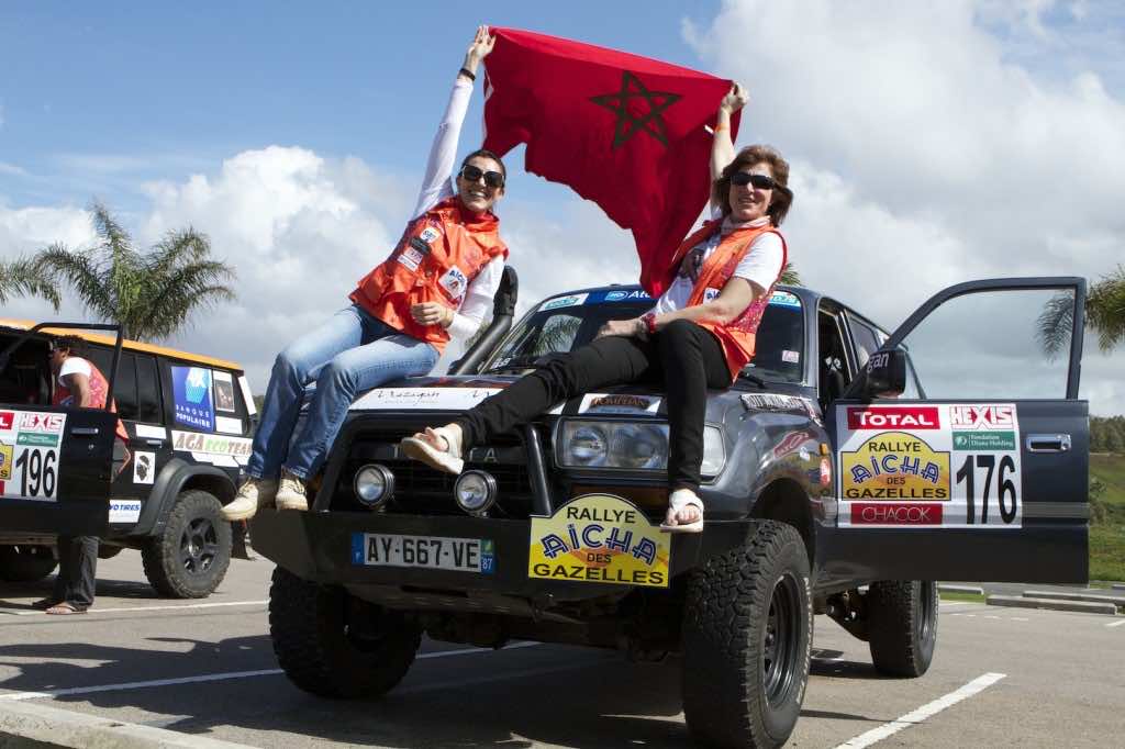 Benedicte Clarkson and  Jamila Ait'Akka waving the Moroccan flag (Picture by Helene Clemenson for Morocco World News)