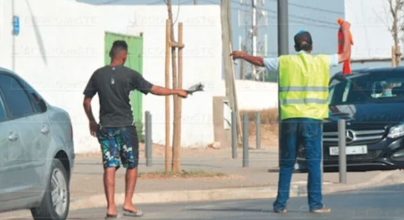 Parking guards take control of streets and pester drivers for money